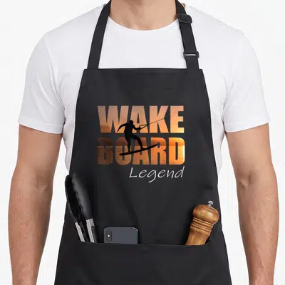 Tablier de cuisine noir avec silhouette wakeboarder et texte Wakeboard Legend en dégradé orange.