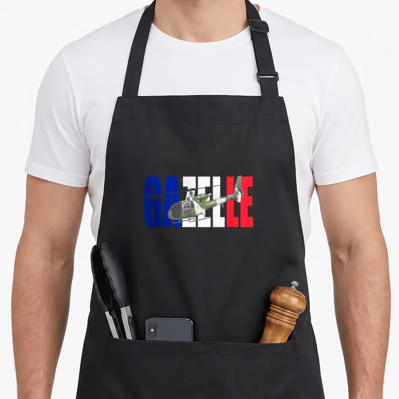 Tablier de cuisine noir avec illustration d'un hélicoptère vert traversant les mots GAZELLE en bleu blanc et rouge.