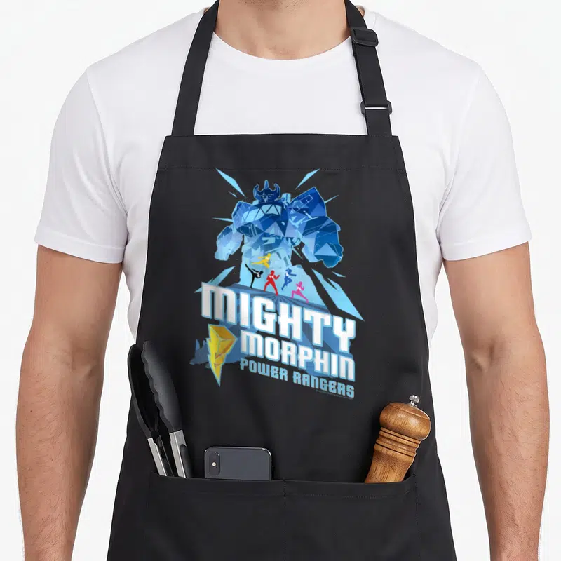 Tablier de cuisine noir avec illustration des Power Rangers et d'un robot géant bleu sous le titre Mighty Morphin.