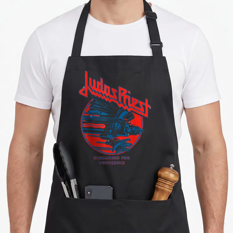 Tablier de cuisine noir avec le logo Judas Priest et un aigle bleu stylisé dans un cercle rouge.