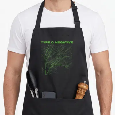 Tablier de cuisine noir avec l'inscription Type O Negative et un arbre aux branches fines en vert fluorescent.