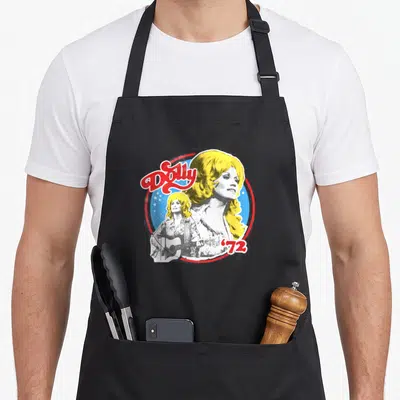 Tablier de cuisine noir avec illustration vintage de Dolly Parton et le chiffre 72 en rouge et bleu.