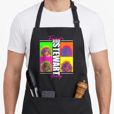 Tablier de cuisine noir avec quatre portraits colorés de Rod Stewart et le texte Forever Young en rose.