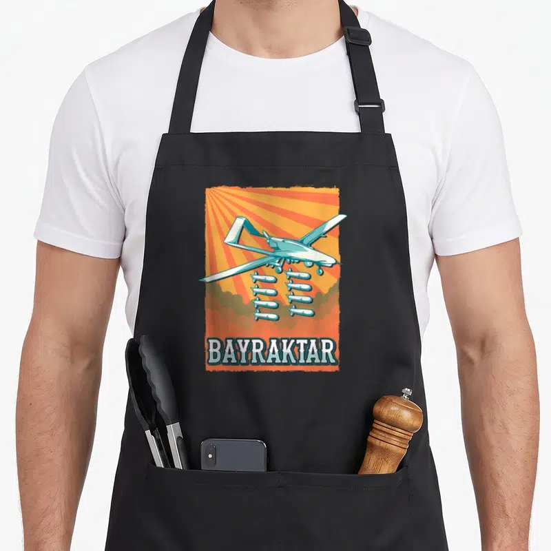 Tablier de cuisine noir avec illustration vintage d'un drone Bayraktar armé de missiles sur fond orange rayonnant.