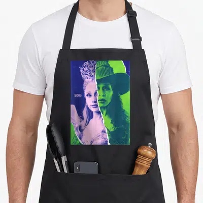 Tablier de cuisine noir avec portrait scindé de Glinda et Elphaba aux couleurs vives.