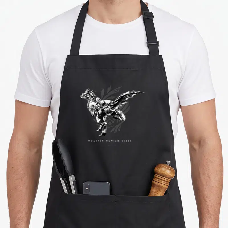 Tablier de cuisine noir avec illustration d'un cavalier ailé et le texte Monster Hunter Wilds en bas.