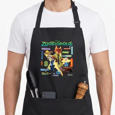 Tablier de cuisine noir avec Judy Hopps, Nick Wilde et divers panneaux de quartiers colorés sur fond jaune étoilé.
