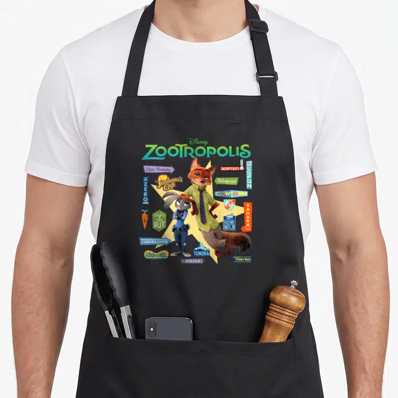 Tablier de cuisine noir avec Judy Hopps, Nick Wilde et divers panneaux de quartiers colorés sur fond jaune étoilé.