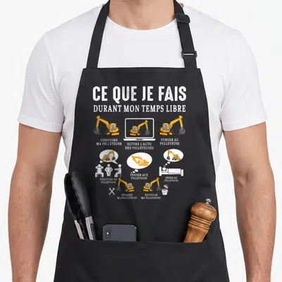 Tablier de cuisine noir avec illustration jaune et blanche sur la passion de la pelleteuse en temps libre.