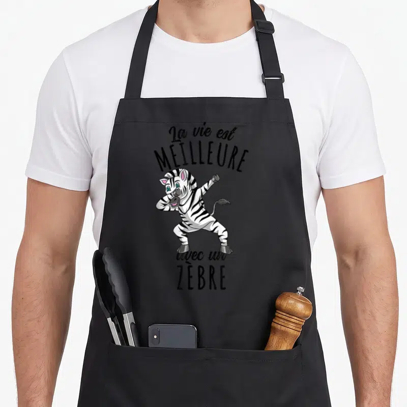 Tablier de cuisine noir avec un zèbre cartoon effectuant la pose dab sous une phrase humoristique.