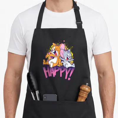 Tablier de cuisine noir avec Jerry et Nibbles souriants et le mot HAPPY en lettres roses stylisées.