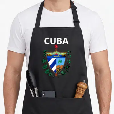 Tablier de cuisine noir avec l'inscription CUBA et les armoiries nationales colorées au centre.