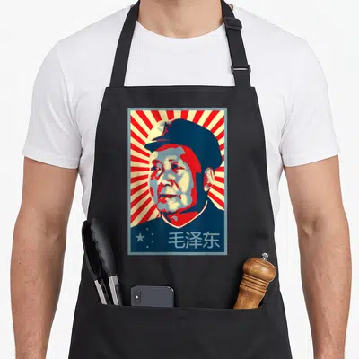 Tablier de cuisine noir avec portrait Mao Zedong Tse Tung style propagande et rayons rouges.