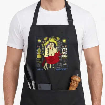 Tablier de cuisine noir avec illustration colorée de Jane's Addiction et texte bleu en bas.
