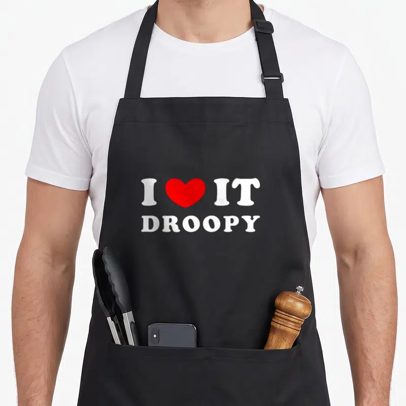 Tablier de cuisine noir avec inscription blanche I Love It Droopy et un cœur rouge au centre.