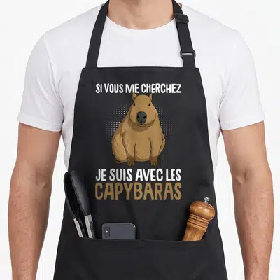 Tablier de cuisine noir avec un capybara marron et le texte Si vous me cherchez je suis avec les capybaras.