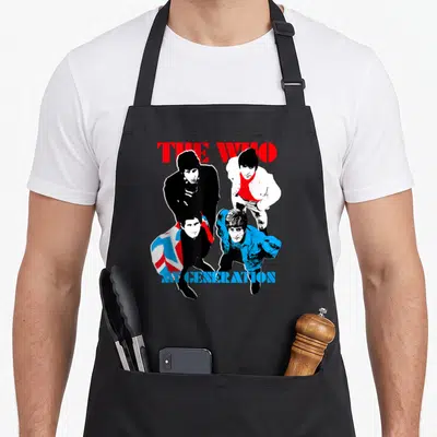 Tablier de cuisine noir avec illustration colorée du groupe The Who et le texte My Generation en bas.