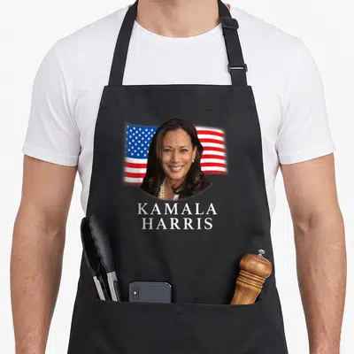 Tablier de cuisine noir avec portrait de Kamala Harris et drapeau américain en arrière-plan