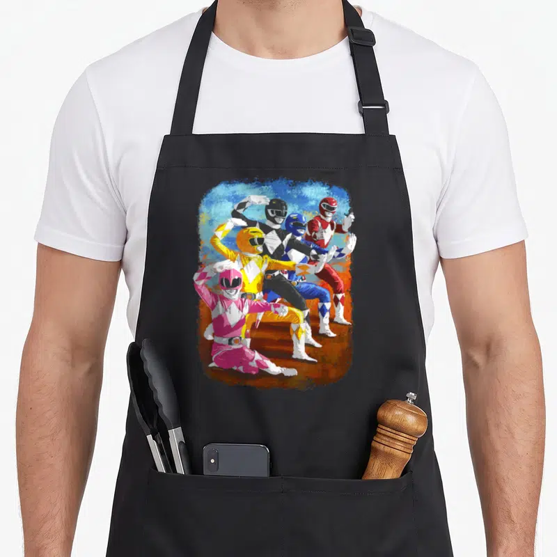 Tablier de cuisine noir avec cinq Power Rangers en pose d'action, style impressionniste aux couleurs vives.