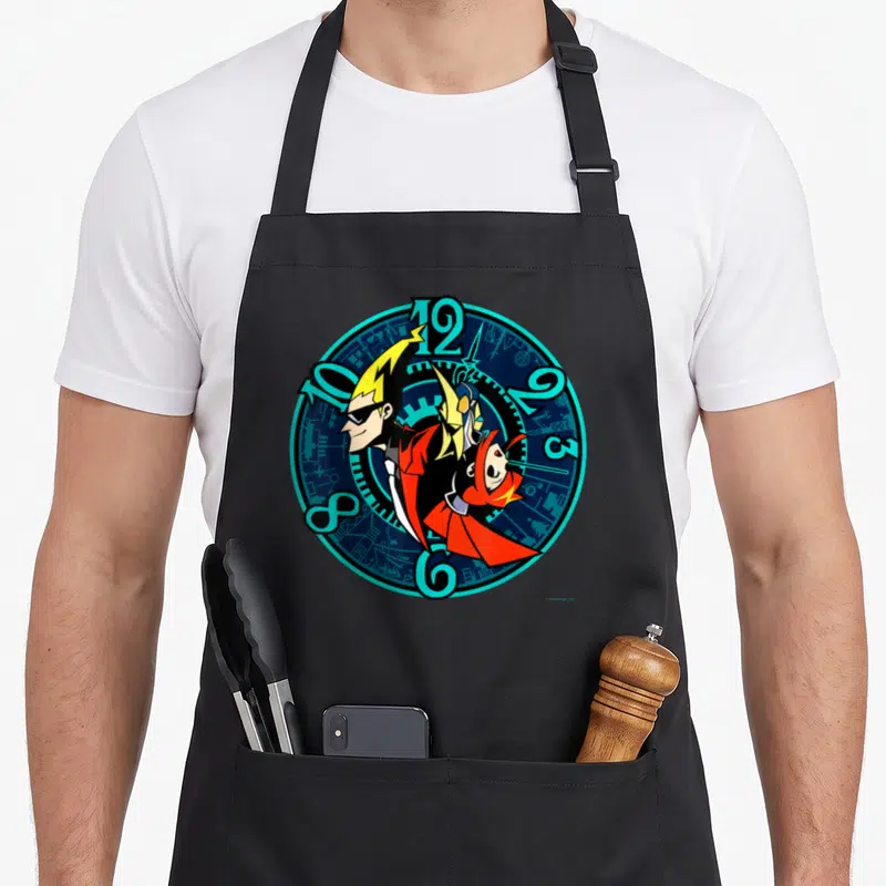 Tablier de cuisine noir avec illustration circulaire d'une horloge et deux personnages aux cheveux blonds et masques rouges.