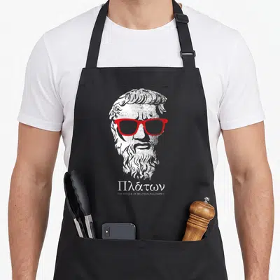 Tablier de cuisine noir avec buste de Platon portant des lunettes rouges et texte en grec.