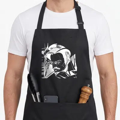 Tablier de cuisine noir avec portrait graphique blanc de Léon Trotsky aux traits anguleux et lunettes rondes.