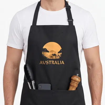 Tablier de cuisine noir avec illustration orange d'un kangourou et le mot Australia au coucher du soleil.