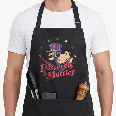 Tablier de cuisine noir avec illustration colorée de Dastardly et Mutley encadrés par un cercle gris texturé.
