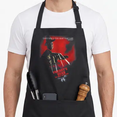 Tablier de cuisine noir avec illustration de Freddy Krueger et texte They Saved The Best For Last sur fond rouge.