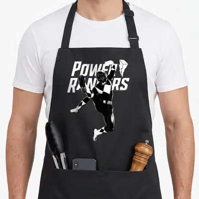Tablier de cuisine noir avec illustration du Black Ranger en saut et texte Power Rangers blanc.