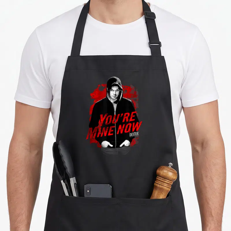 Tablier de cuisine noir avec illustration Dexter Dark Passenger et texte You're Mine Now en rouge.
