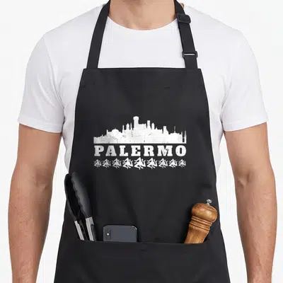 Tablier de cuisine noir avec silhouette blanche de Palermo, texte PALERMO et motifs stylisés en bas.