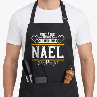 Tablier de cuisine noir avec inscription Voici à quoi ressemble le meilleur Nael Du Monde et deux pouces levés.