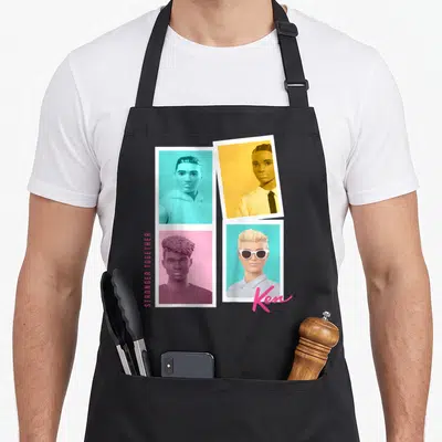 Tablier de cuisine noir avec quatre portraits d'Enfant Ken sur fonds turquoise, orange, rose et le logo Ken en bas à droite.