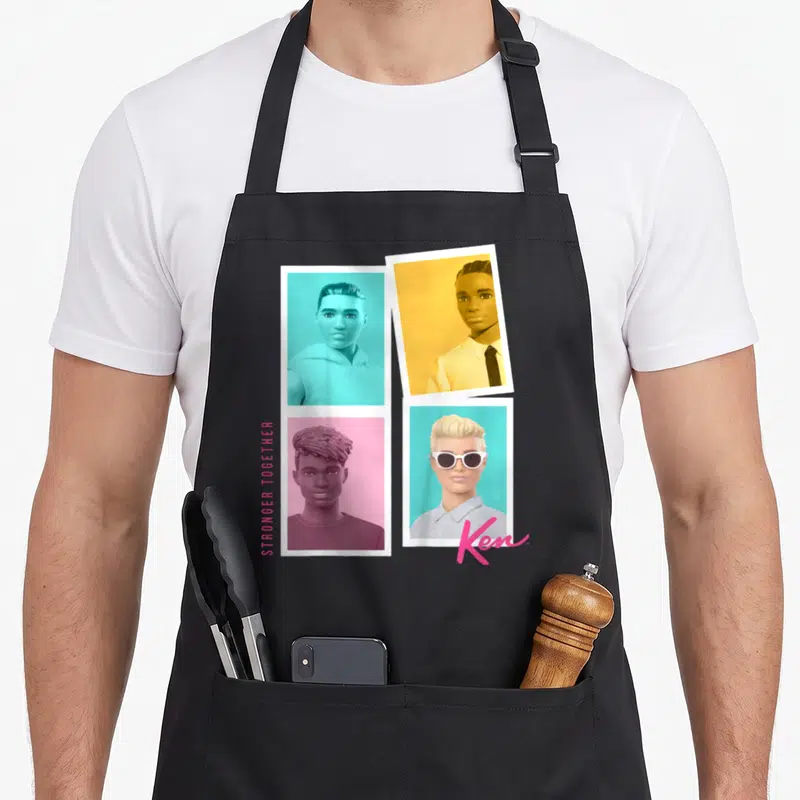 Tablier de cuisine noir avec quatre portraits d'Enfant Ken sur fonds turquoise, orange, rose et le logo Ken en bas à droite.