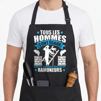 Tablier de cuisine noir avec silhouette ramoneur échelle et cheminées texte blanc et bleu