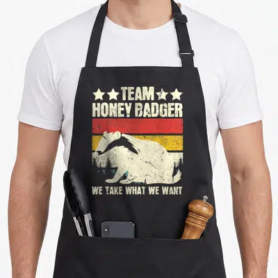 Tablier de cuisine noir avec illustration vintage d'un blaireau de miel et le texte Team Honey Badger We Take What We Want.