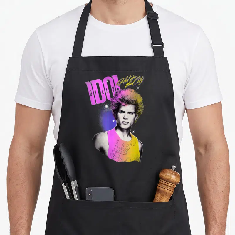 Tablier de cuisine noir avec portrait coloré de Billy Idol et texte IDOL Hot in the City