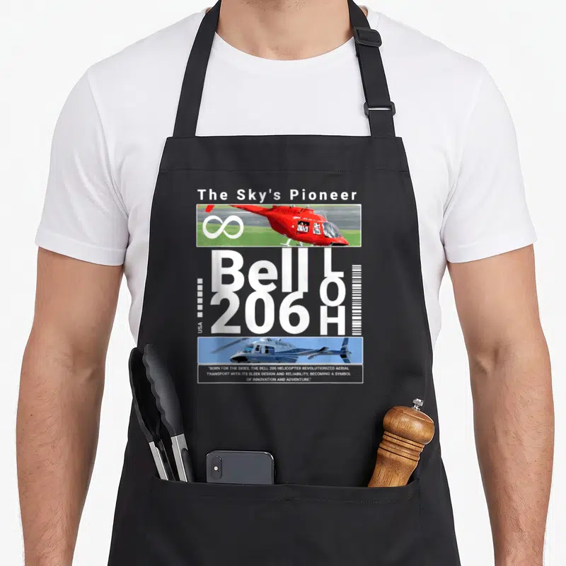 Tablier de cuisine noir avec illustration du Bell 206H rouge et blanc et texte The Sky's Pioneer.