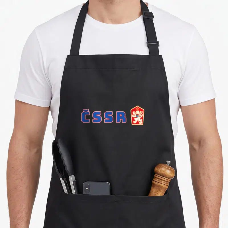 Tablier de cuisine noir avec inscription CSSR et blason rouge orné d'un lion blanc couronné d'une étoile.