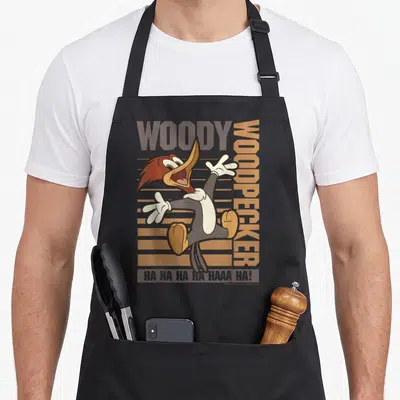 Tablier de cuisine noir avec illustration colorée de Woody Woodpecker sautant et texte Ha Ha Ha Haaa Ha en bas.