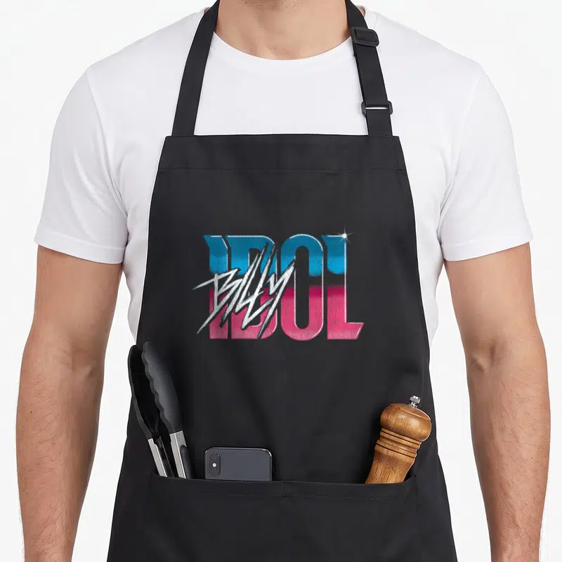 Tablier de cuisine noir avec le logo Billy Idol en dégradé bleu et rose sur fond gris uni.