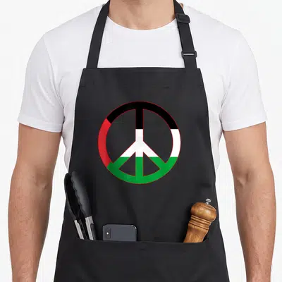 Tablier de cuisine noir avec le symbole de la paix aux couleurs du drapeau palestinien.
