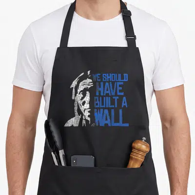 Tablier de cuisine noir avec silhouette grise et texte bleu We Should Have Built A Wall