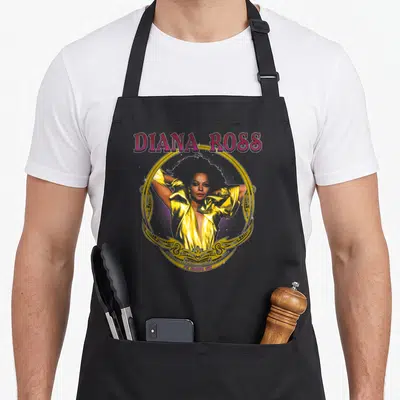 Tablier de cuisine noir avec une illustration dorée de Diana Ross et le texte I'm Coming Out en bas.