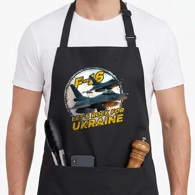 Tablier de cuisine noir avec illustration d'un avion F-16 et le texte Let's Rock for Ukraine en jaune.