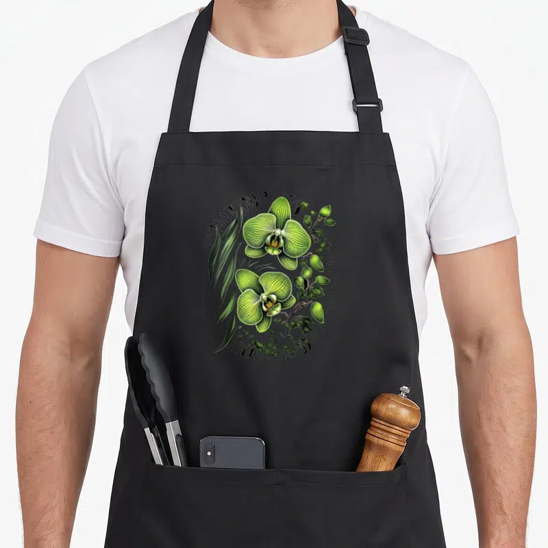 Tablier de cuisine noir avec une illustration colorée de Phalaenopsis Orchidée verte et ses feuilles.