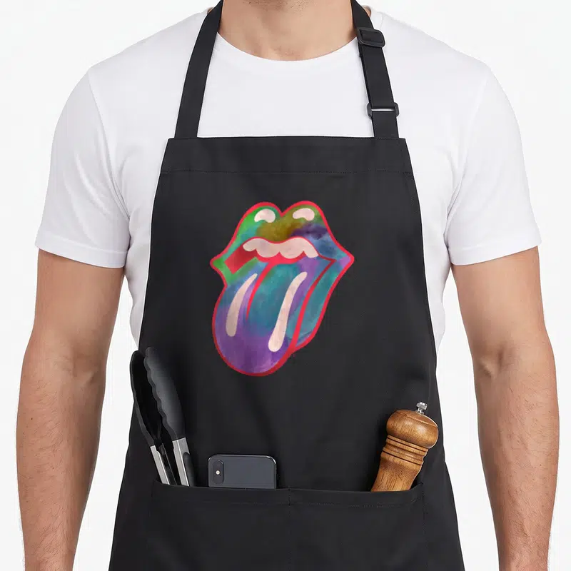 Tablier de cuisine noir avec une illustration colorée d'une bouche et d'une langue au style aquarelle sur fond uni.