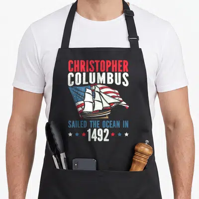 Tablier de cuisine noir avec illustration navire et texte Christopher Columbus Sailed the Ocean in 1492.