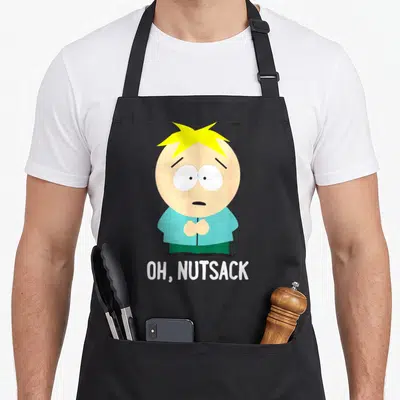 Tablier de cuisine noir avec illustration de Butters et le texte Oh, Nutsack en bas.
